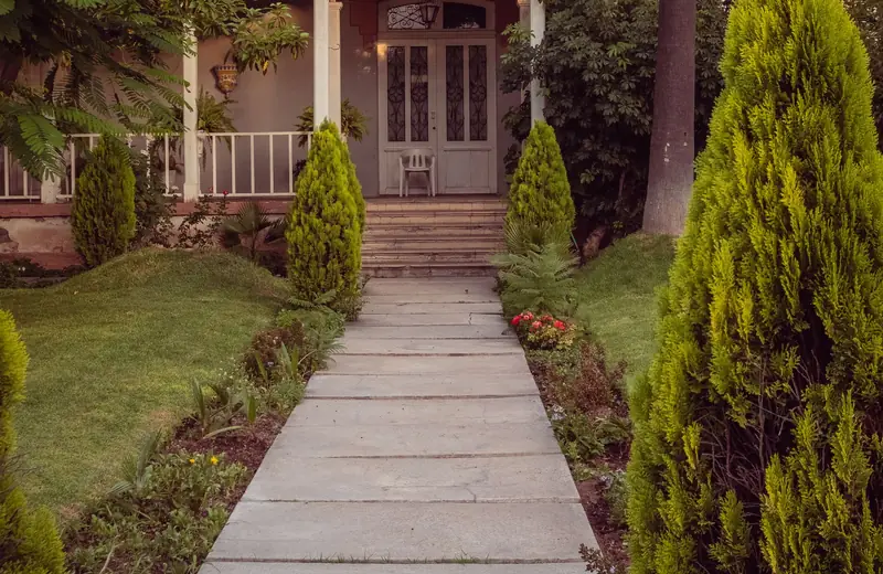 Concrete walkway leading to a house entrance